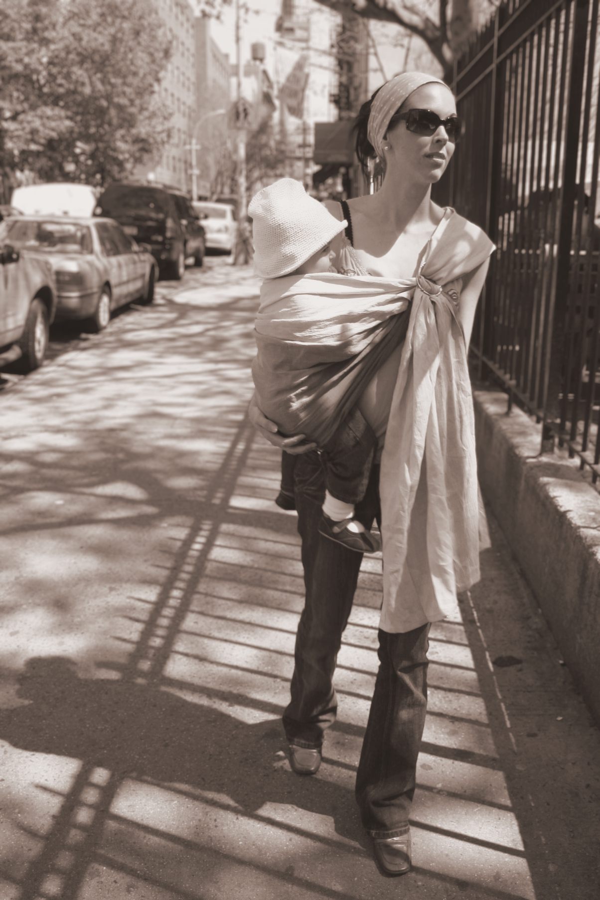 Woman carrying a baby in a ring sling on a SoHo street in New York
