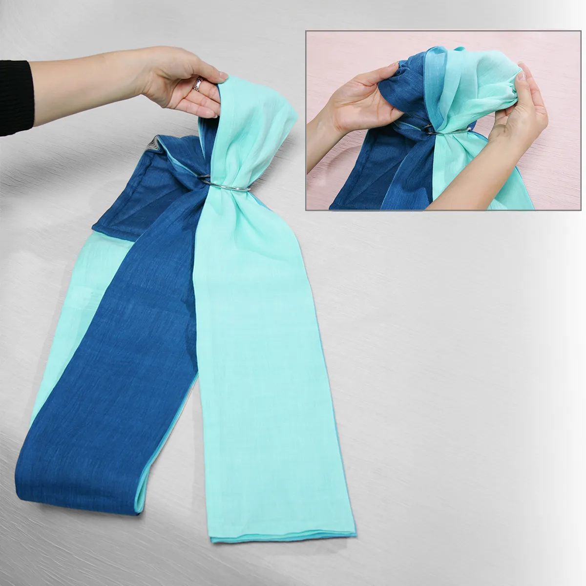 Step 02: Gather the tail end toward the center with both hands. This ensures the fabric flows effortlessly through the rings.