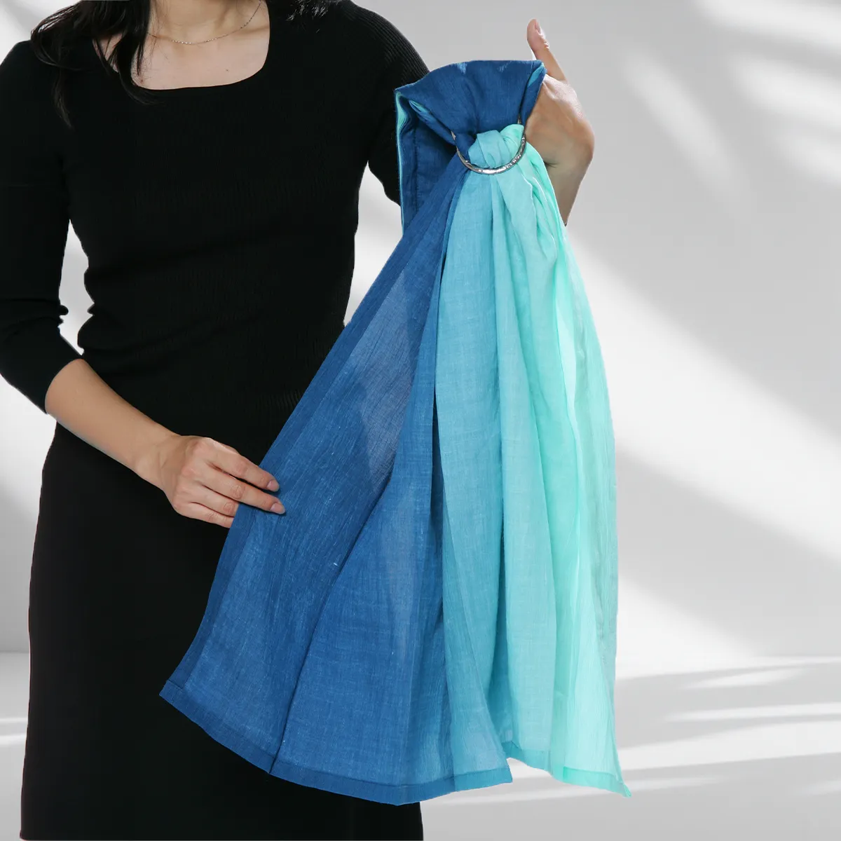 Step 05: Identifying the Shoulder. Identify your natural carrying side. Hold the rings in one hand, allowing the fabric to drape gracefully, ready to be swept across your heart.