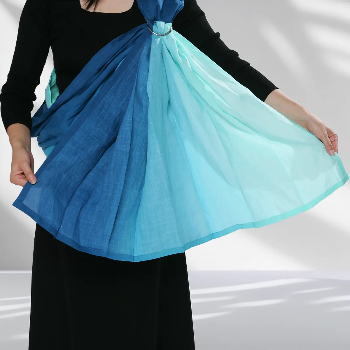 Step 12: The Final Veil. Spread the tail end to refine the fit and provide a sense of privacy. Now, both you and your child can breathe in the shared rhythm of comfort.